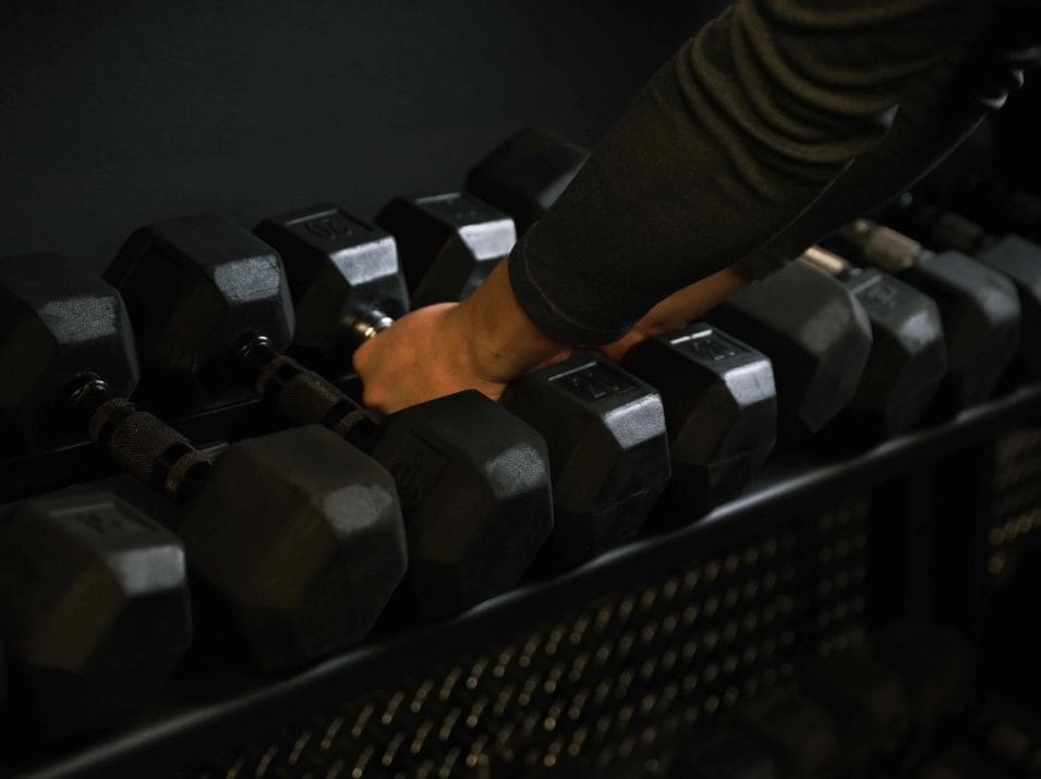 Gritlabs Fitness Person Picking Up Dumbbells